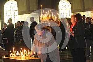 People light candles during festive prayer in church